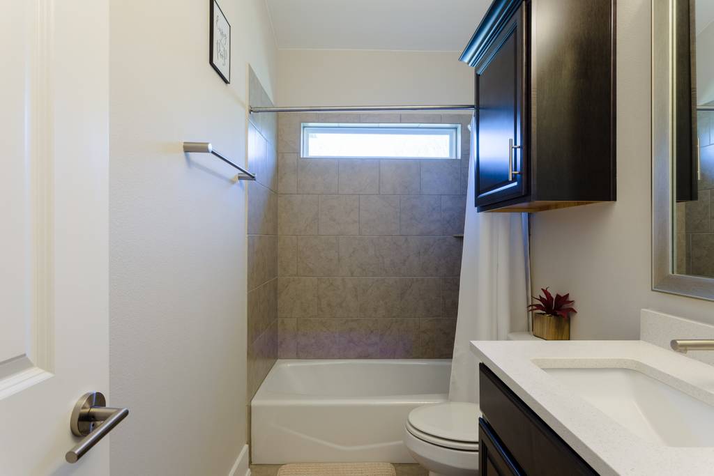 807 East 16th Street, Unit A Austin, TX 78702 - Photo 24 of 29 a bathroom with a granite countertop sink toilet and shower