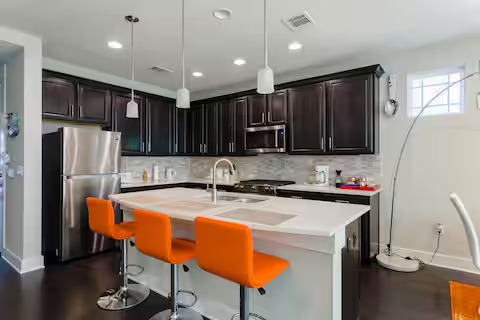 807 East 16th Street, Unit A Austin, TX 78702 - Photo 9 of 29 a kitchen with stainless steel appliances granite countertop a sink refrigerator and cabinets