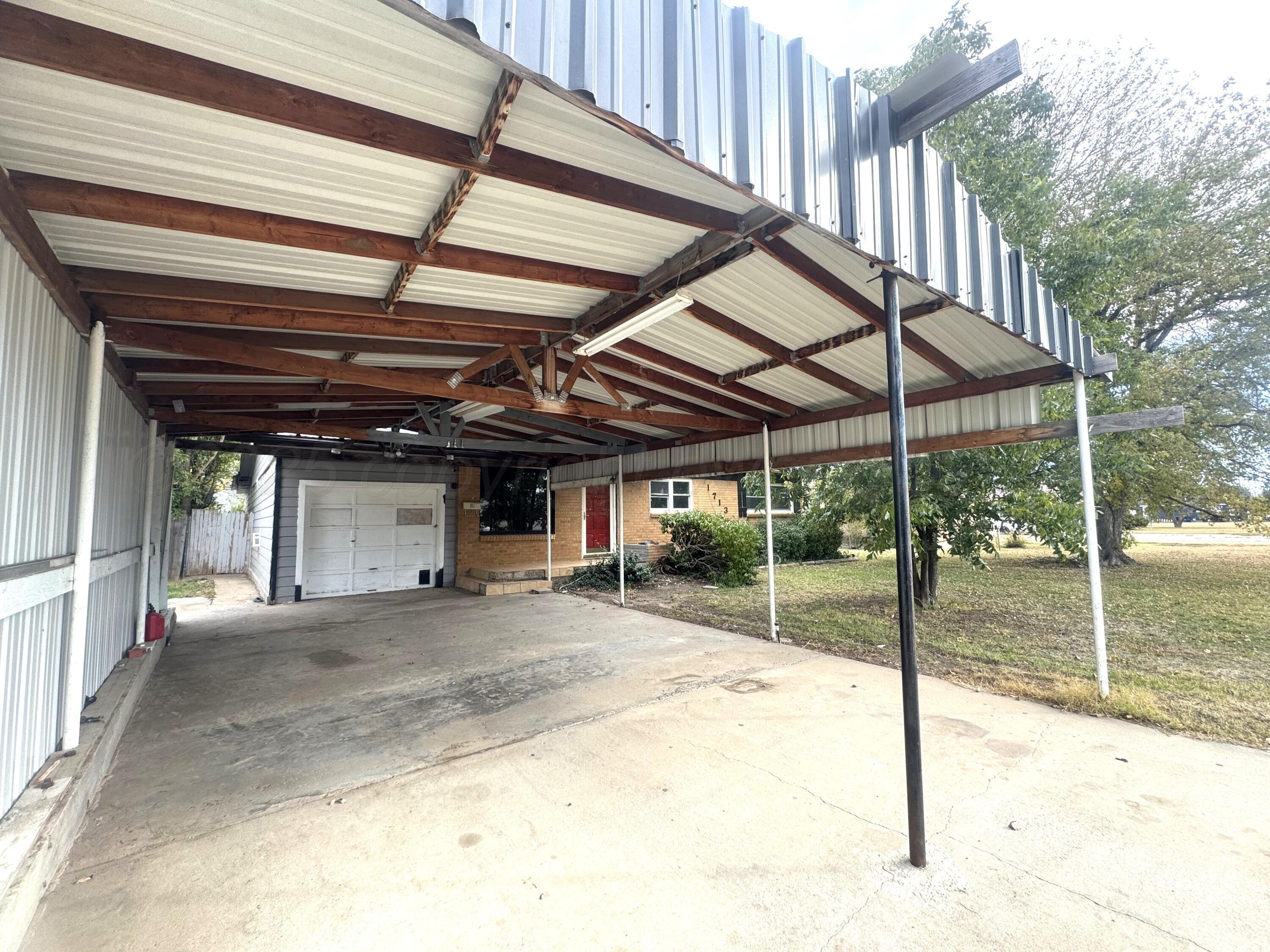 1713 South Drake Street Perryton, TX 79070 - Photo 2 of 13 a car parked in front of garage