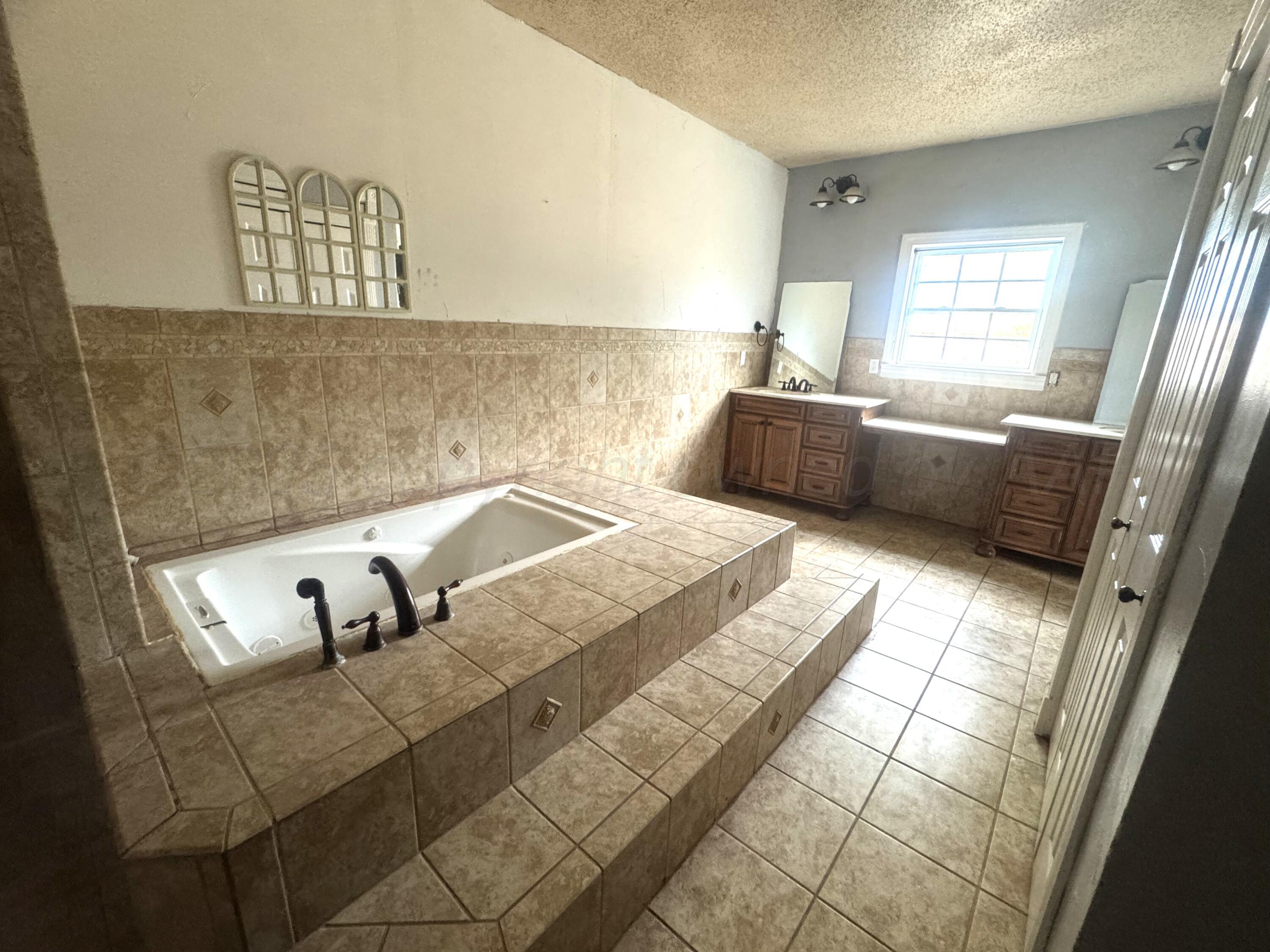 1713 South Drake Street Perryton, TX 79070 - Photo 10 of 13 a bedroom with a bed and a window