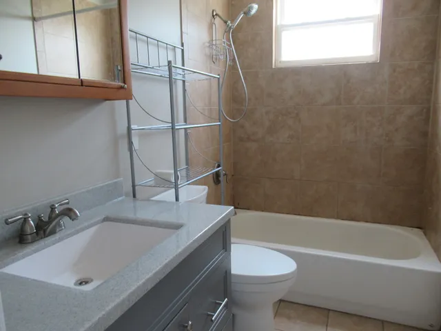 a bathroom with a sink a toilet and bathtub