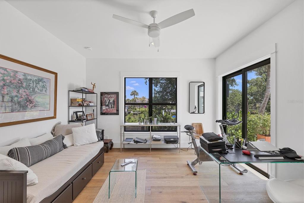 4624 Pompano Street Placida, FL 33946 - Photo 20 of 39 a living room with furniture floor to ceiling window and a flat screen tv
