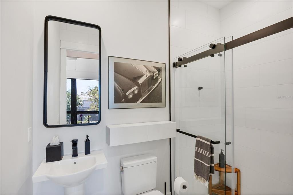 4624 Pompano Street Placida, FL 33946 - Photo 22 of 39 a bathroom with a toilet sink and mirror