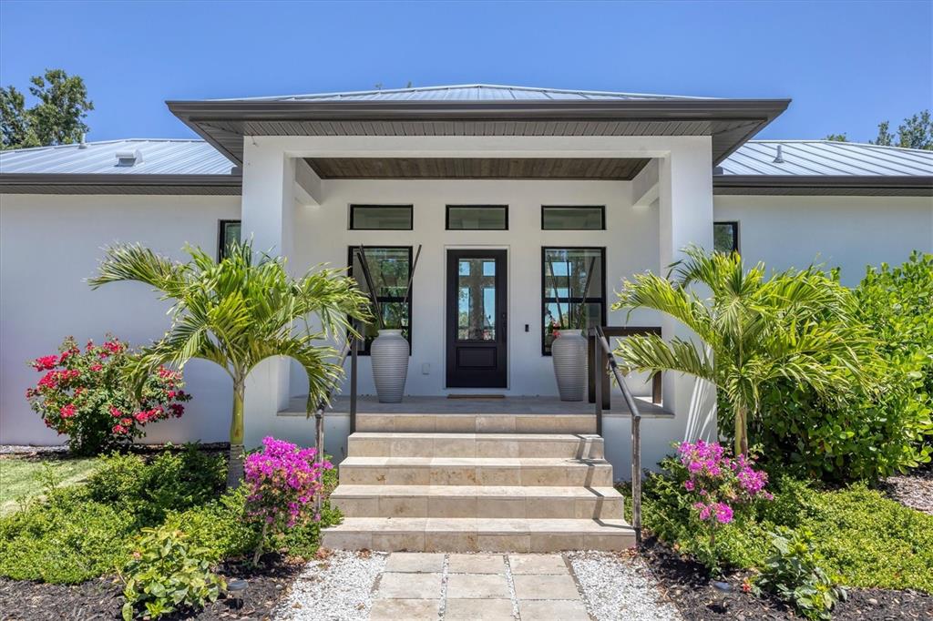 4624 Pompano Street Placida, FL 33946 - Photo 3 of 39 a front view of a house with plants