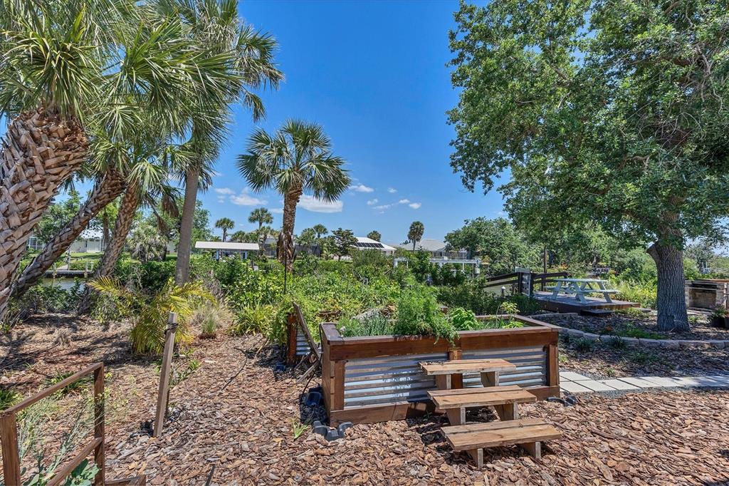 4624 Pompano Street Placida, FL 33946 - Photo 31 of 39 a wooden bench sitting in backyard of a house