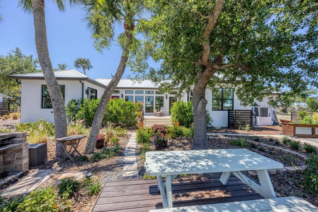 4624 Pompano Street Placida, FL 33946 - Photo 32 of 39 a front view of a house with garden