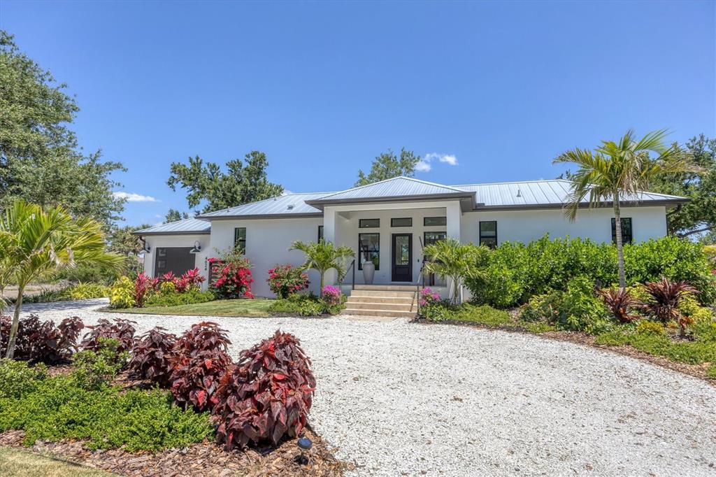 4624 Pompano Street Placida, FL 33946 - Photo 39 of 39 a front view of a house with a yard and outdoor seating