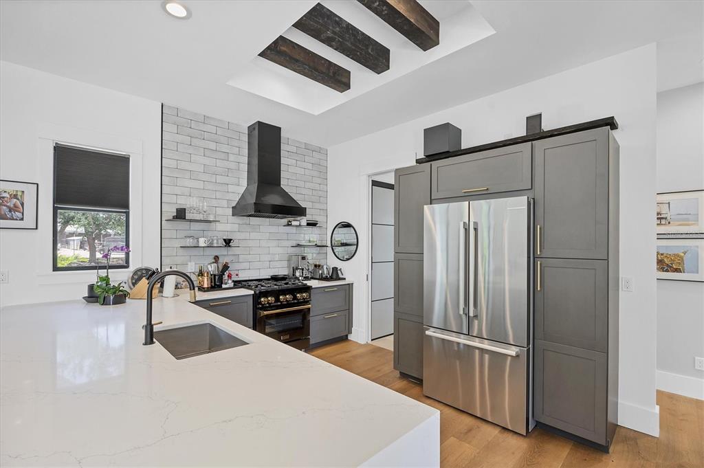 4624 Pompano Street Placida, FL 33946 - Photo 6 of 39 a kitchen with stainless steel appliances granite countertop a refrigerator a stove and a sink with wooden floor