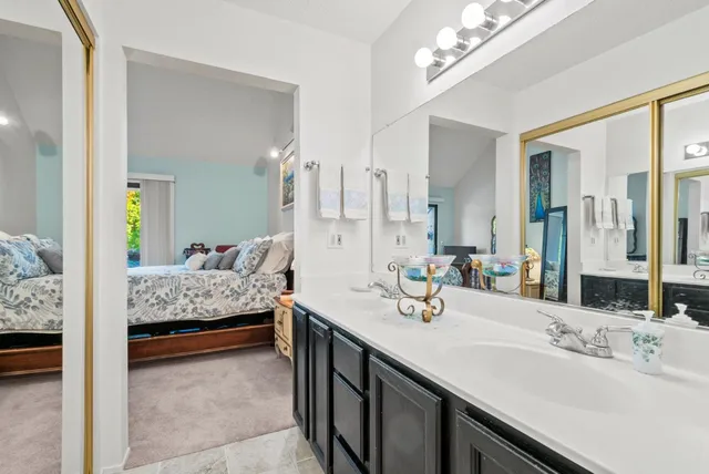 a en suite bathroom with double sink and a mirror