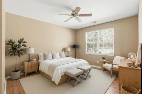 a bedroom with a bed couch and window