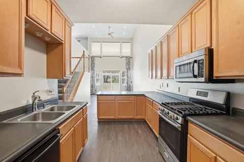 a kitchen with stainless steel appliances a sink stove and cabinets