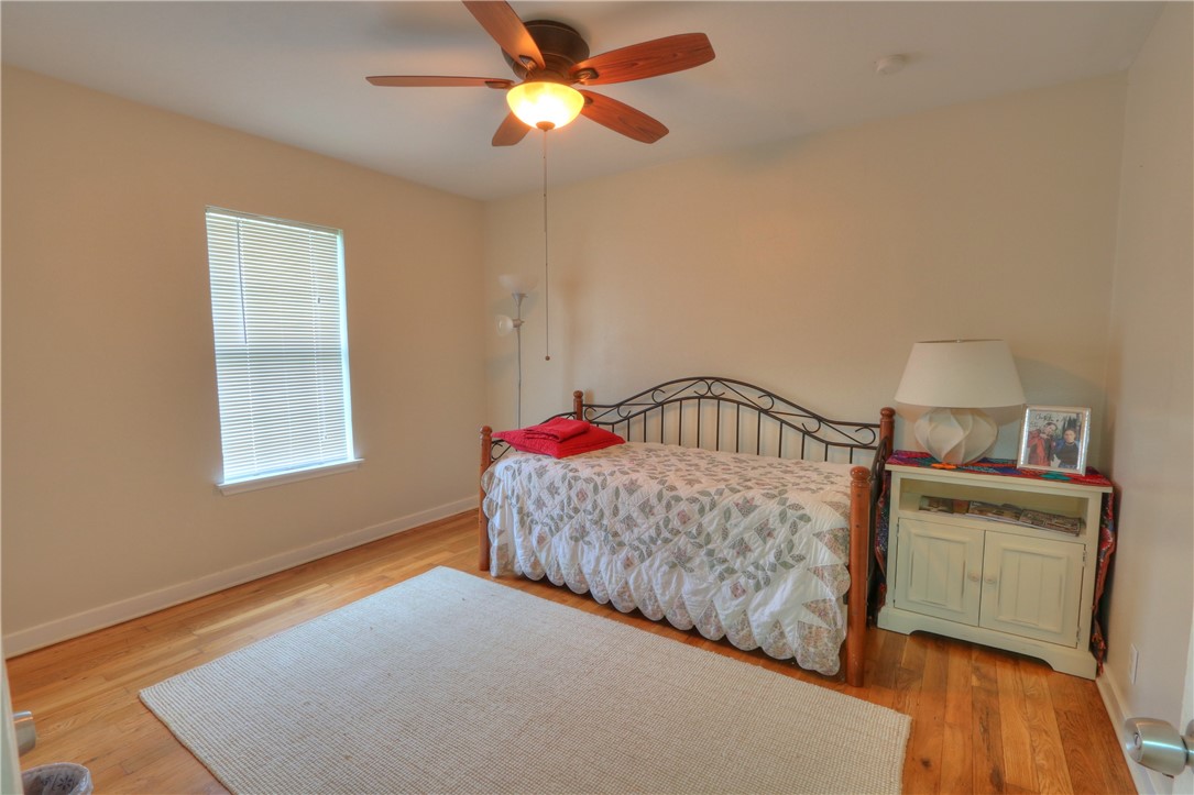 3538 Austin Street Corpus Christi, TX 78411 - Photo 17 of 21 a bedroom with a bed and a chandelier