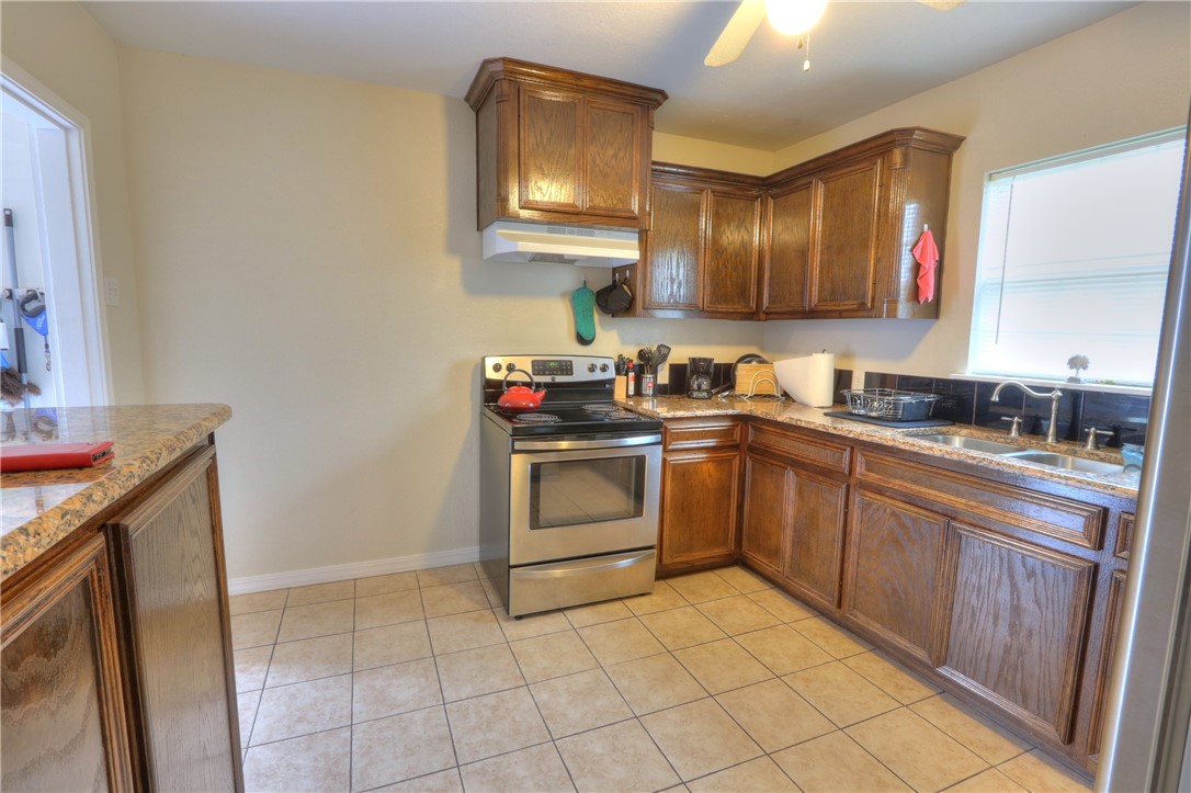 3538 Austin Street Corpus Christi, TX 78411 - Photo 10 of 21 a kitchen with a stove sink and cabinets