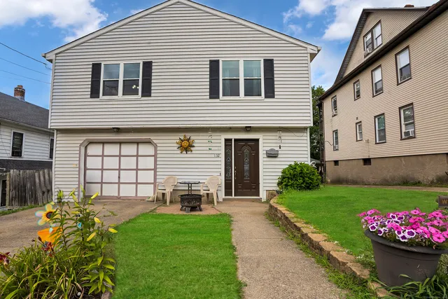 a front view of a house with a garden