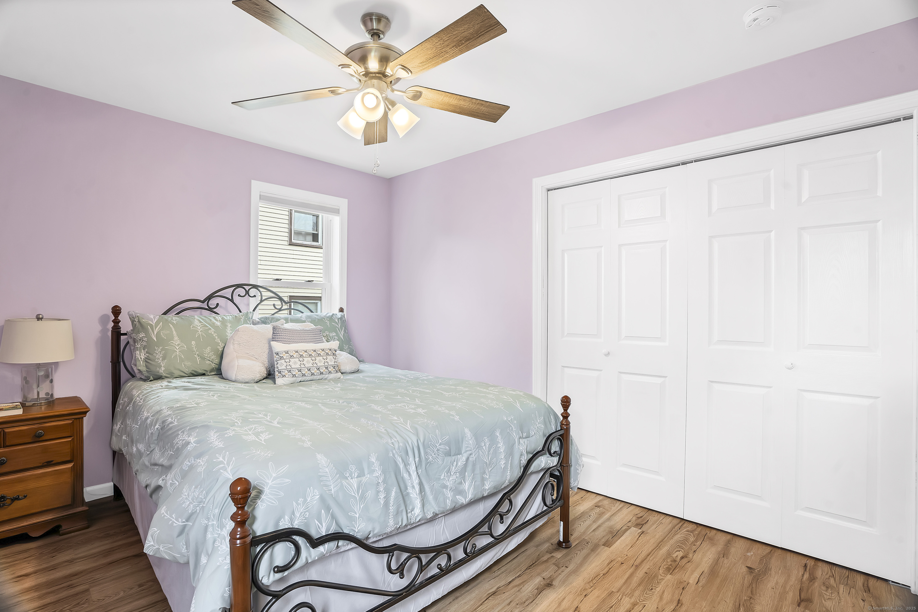 132 Howard Avenue Ansonia, CT 06401 - Photo 11 of 16 a bedroom with a bed and a chandelier