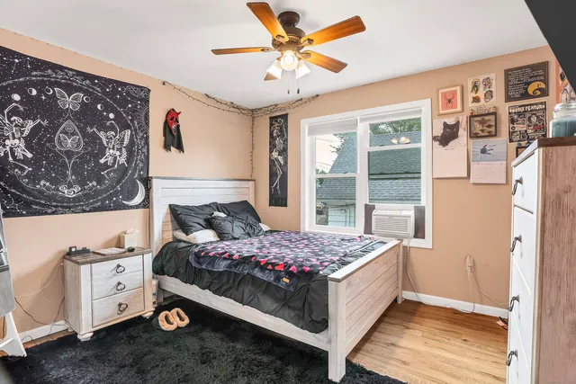 a bedroom with a bed and a window