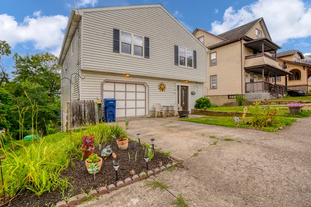 a front view of a house with a yard and a garage