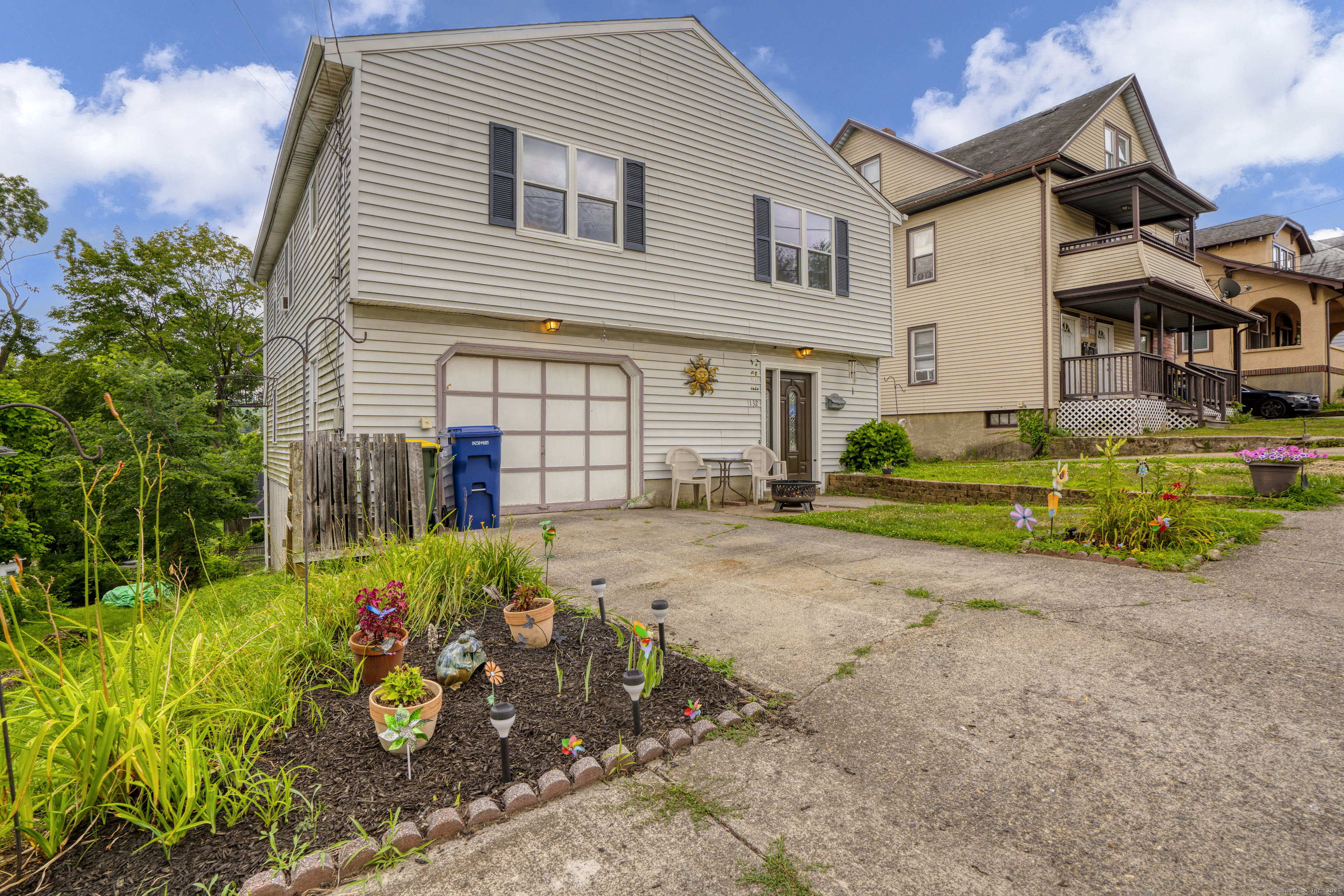 132 Howard Avenue Ansonia, CT 06401 - Photo 2 of 16 a front view of a house with a yard and a garage