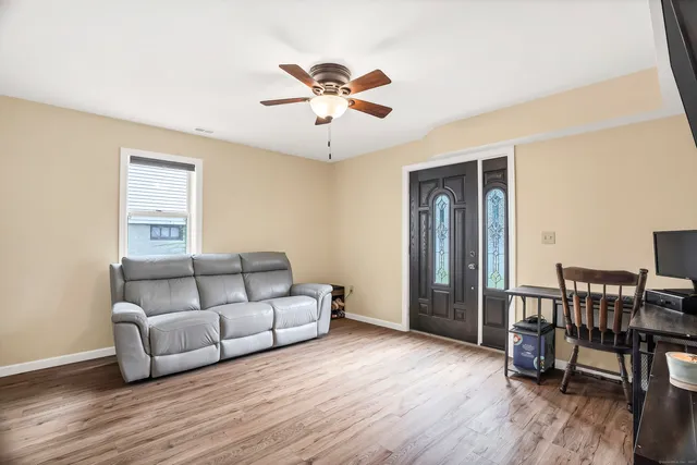 a living room with furniture and a wooden floor