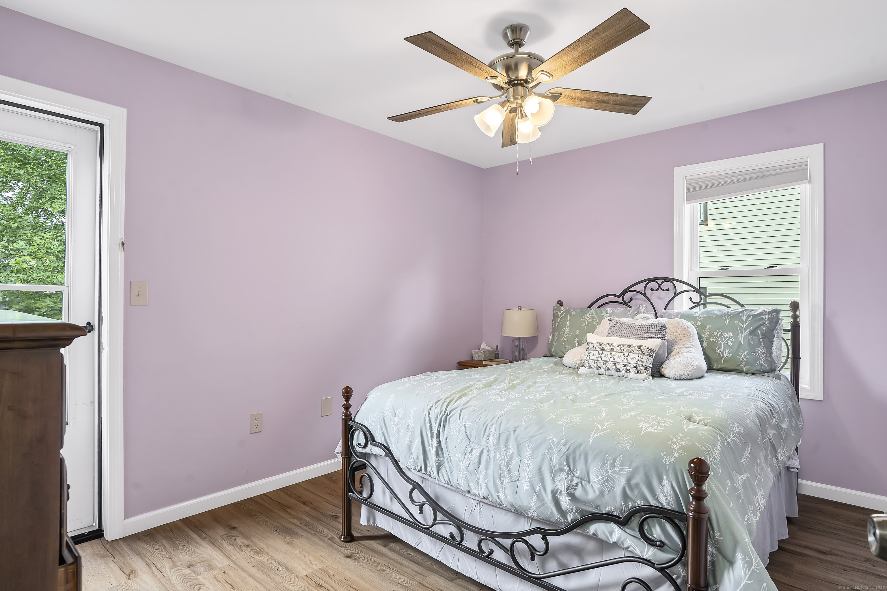 132 Howard Avenue Ansonia, CT 06401 - Photo 10 of 16 a bedroom with a bed and a chandelier