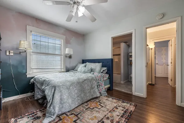a bedroom with a bed and wooden floor