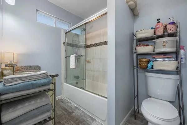 a bathroom with a toilet and a shower