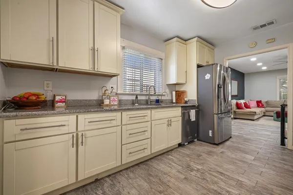 a kitchen with cabinets and appliances