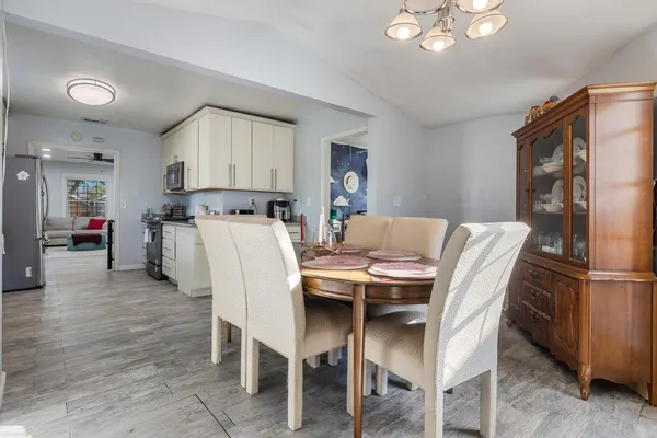 a dining room with furniture and window