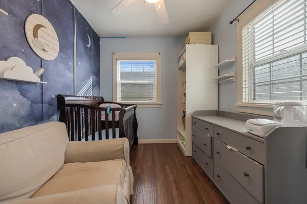 a living room with furniture a window and wooden floor