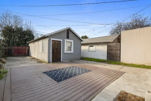 a view of a house with a wooden deck