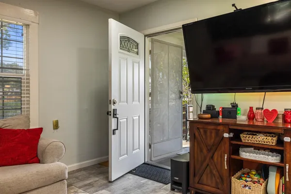 a view of a livingroom with furniture and a flat screen tv