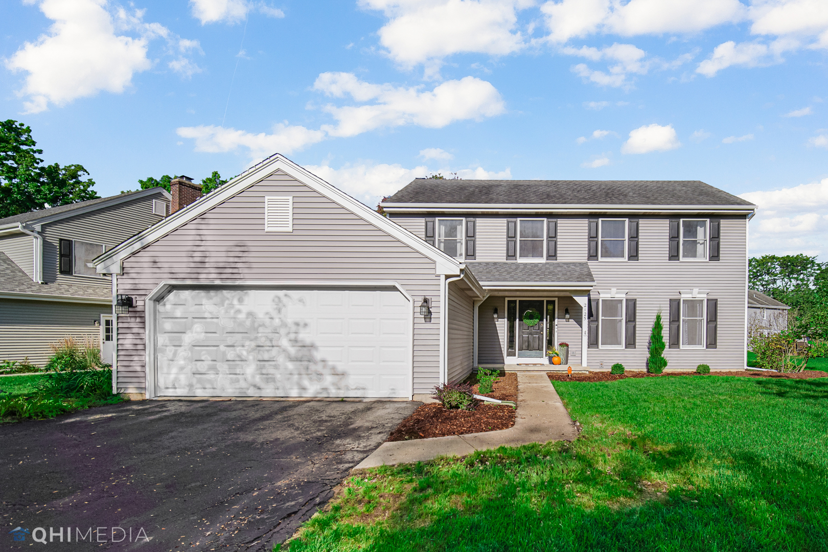 2125 Forest Ridge Road St. Charles, IL 60174 - Photo 1 of 28 a front view of a house with a garden and plants