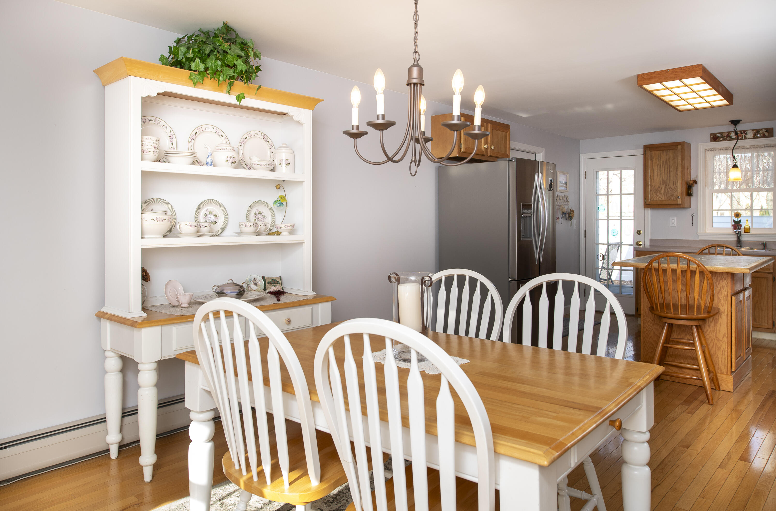 31 Mashpee Neck Road Mashpee, MA 02649 - Photo 11 of 65 a view of a dining room with furniture wooden floor and chandelier