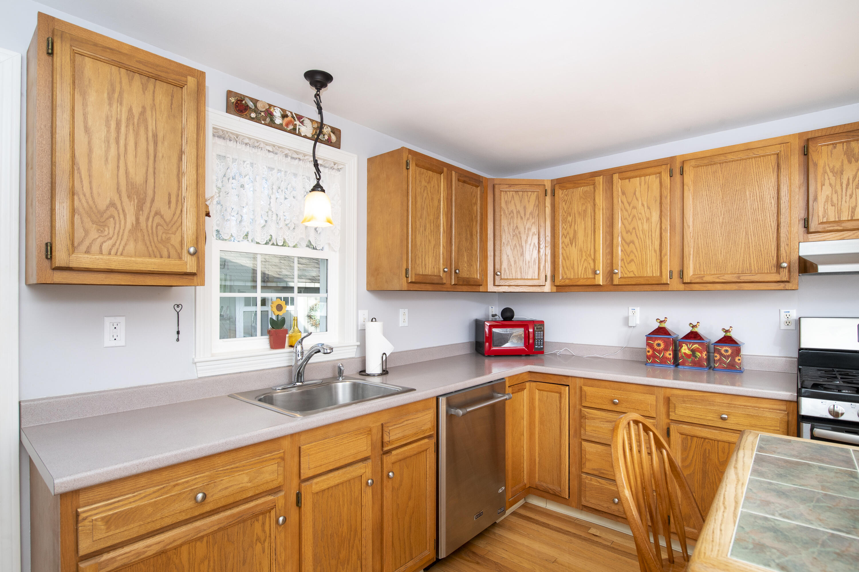 31 Mashpee Neck Road Mashpee, MA 02649 - Photo 12 of 65 a kitchen with stainless steel appliances wooden cabinets sink and a window