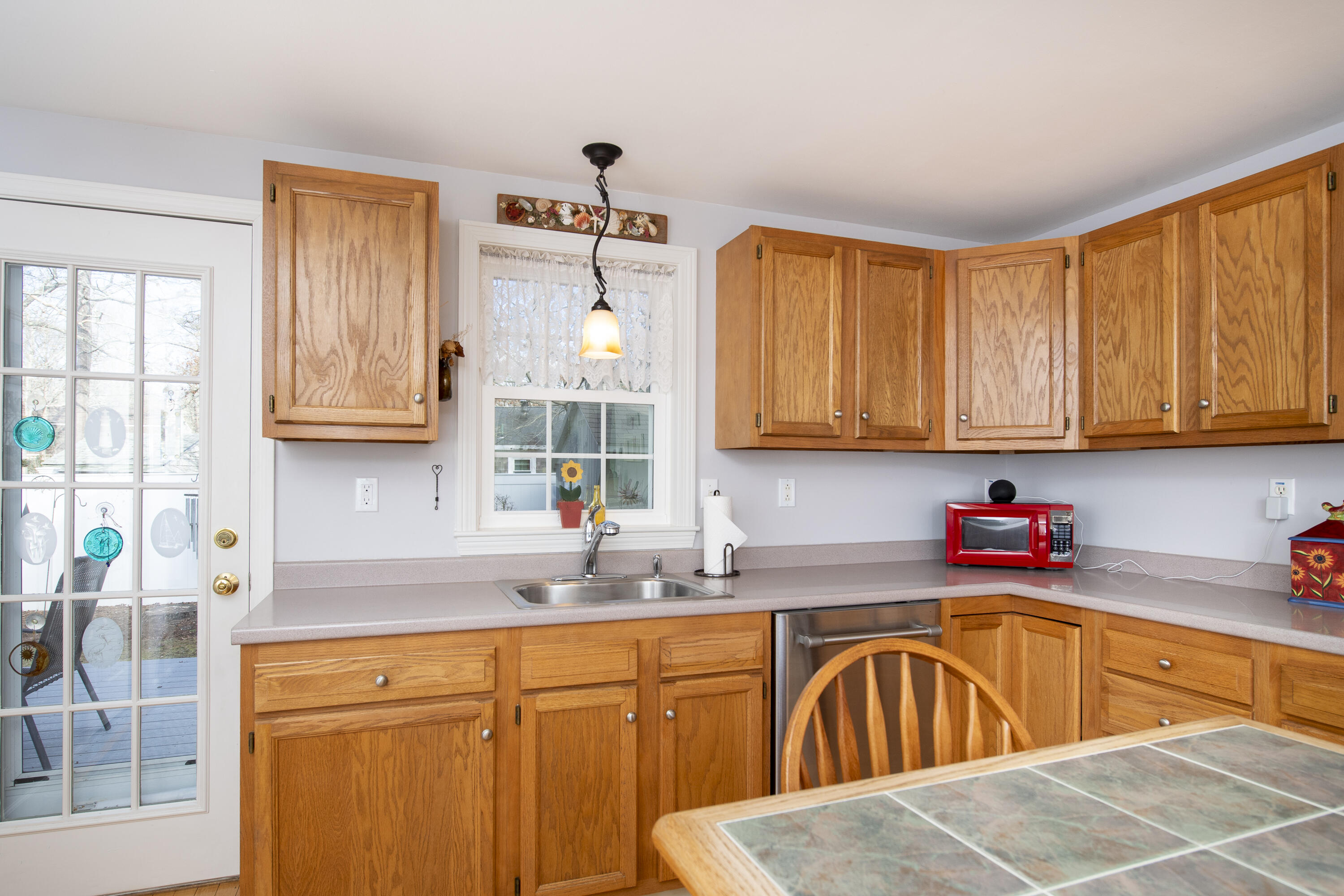 31 Mashpee Neck Road Mashpee, MA 02649 - Photo 13 of 65 a kitchen with stainless steel appliances granite countertop a sink window and cabinets