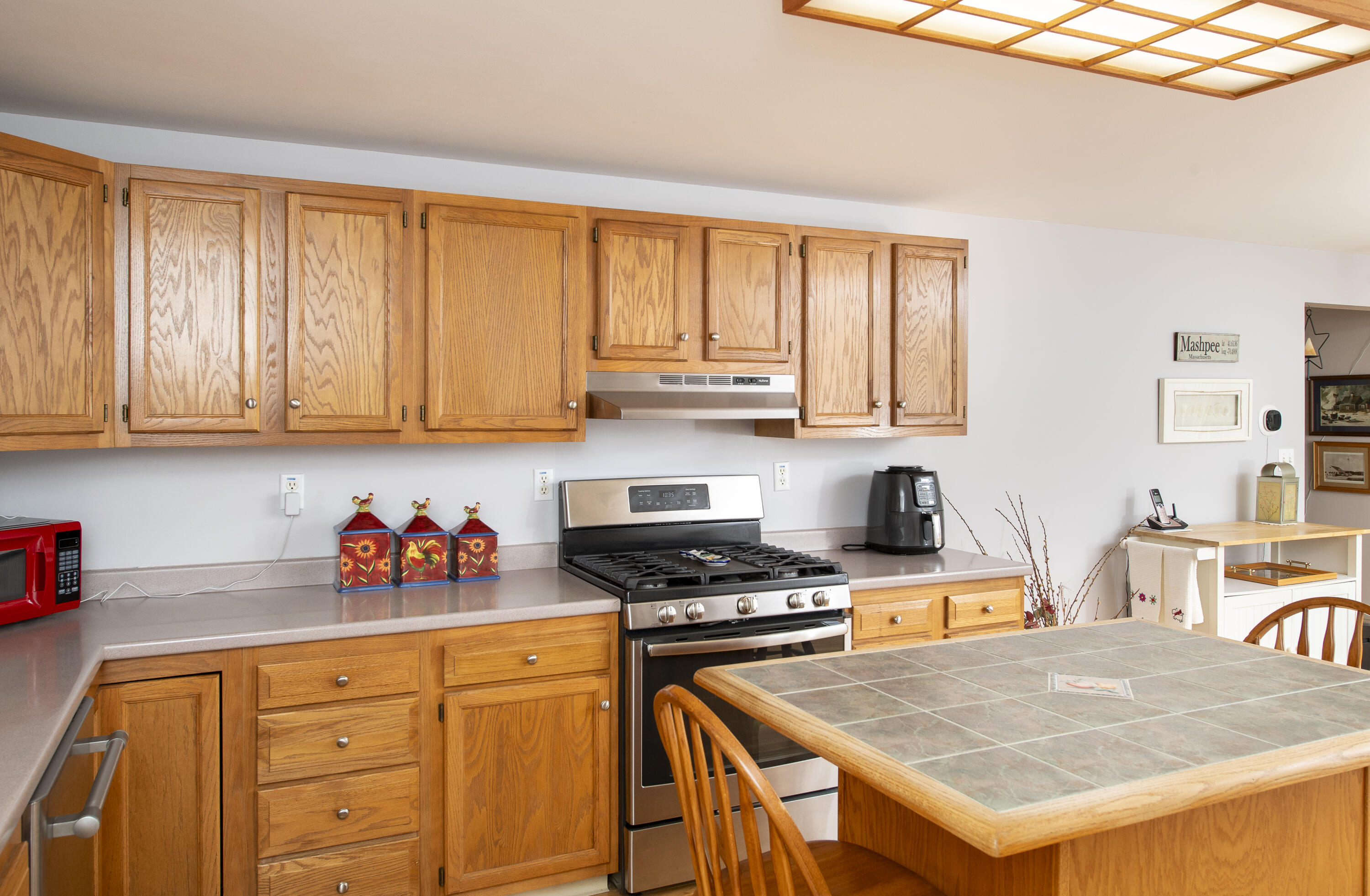31 Mashpee Neck Road Mashpee, MA 02649 - Photo 14 of 65 a kitchen with stainless steel appliances granite countertop a stove refrigerator sink and cabinets