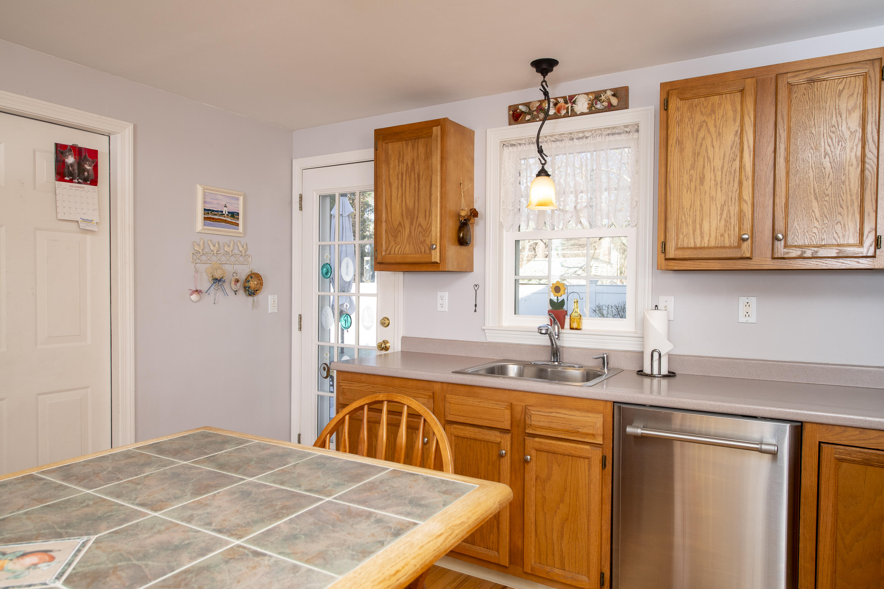 31 Mashpee Neck Road Mashpee, MA 02649 - Photo 16 of 65 a kitchen with stainless steel appliances granite countertop a sink dishwasher and cabinets with wooden floor