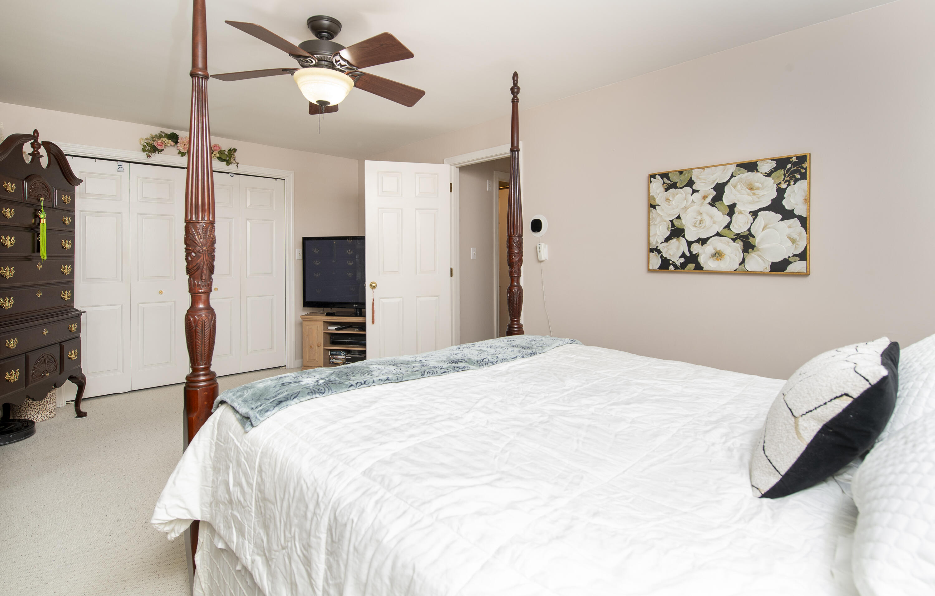31 Mashpee Neck Road Mashpee, MA 02649 - Photo 28 of 65 a bedroom with a bed and a chandelier