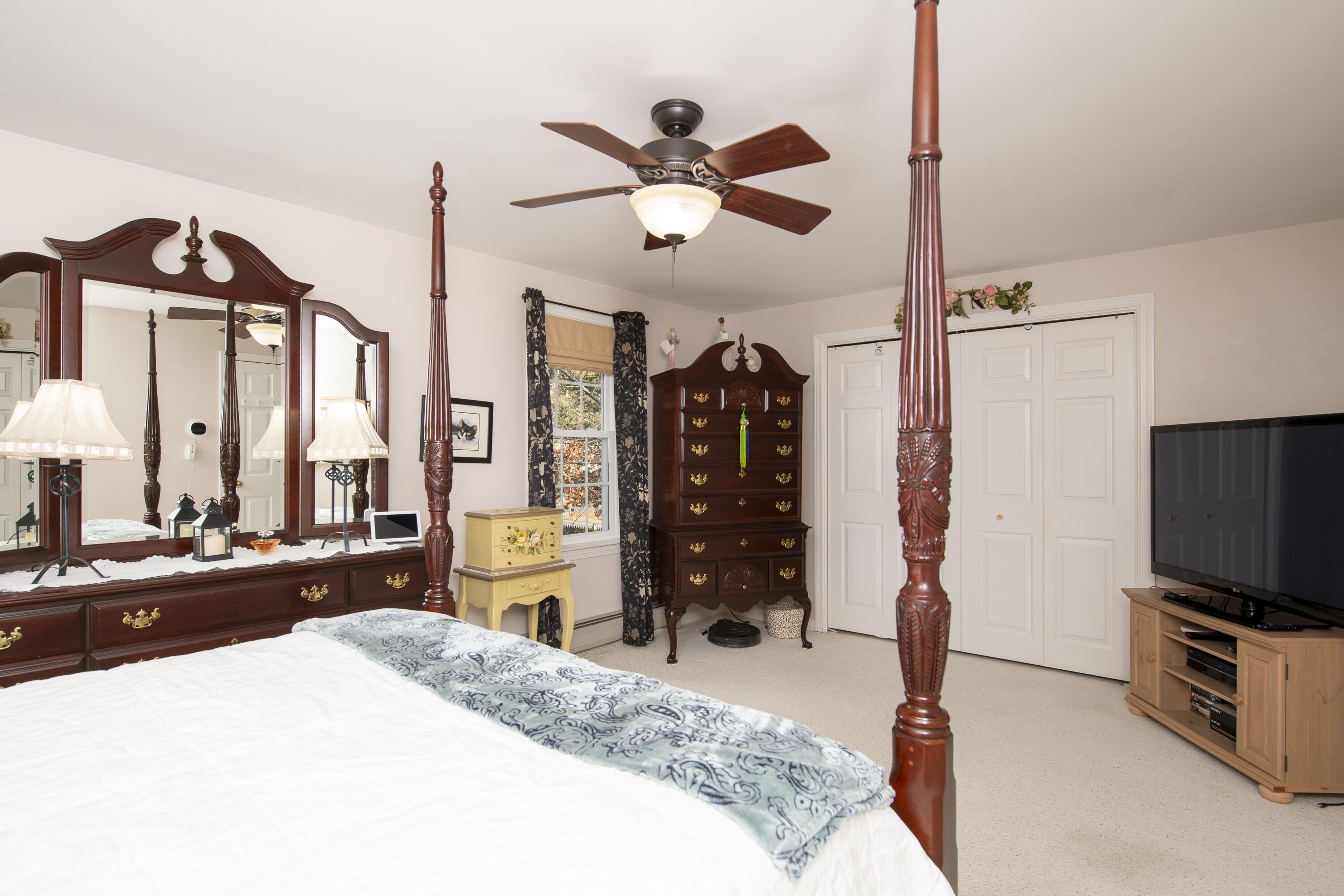 31 Mashpee Neck Road Mashpee, MA 02649 - Photo 29 of 65 a bedroom with a bed and a flat screen tv