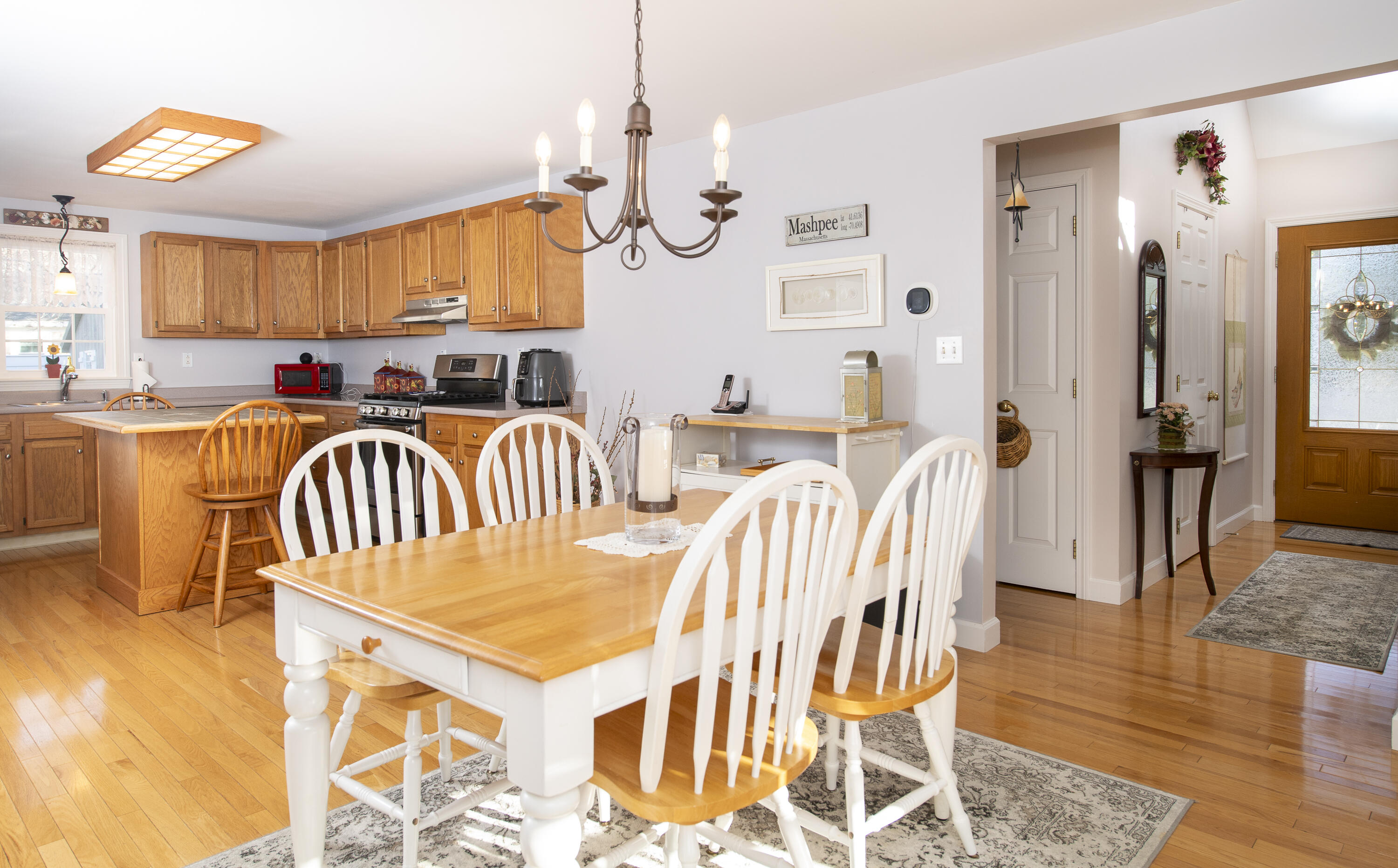31 Mashpee Neck Road Mashpee, MA 02649 - Photo 4 of 65 a open kitchen with a table chairs and a dining table