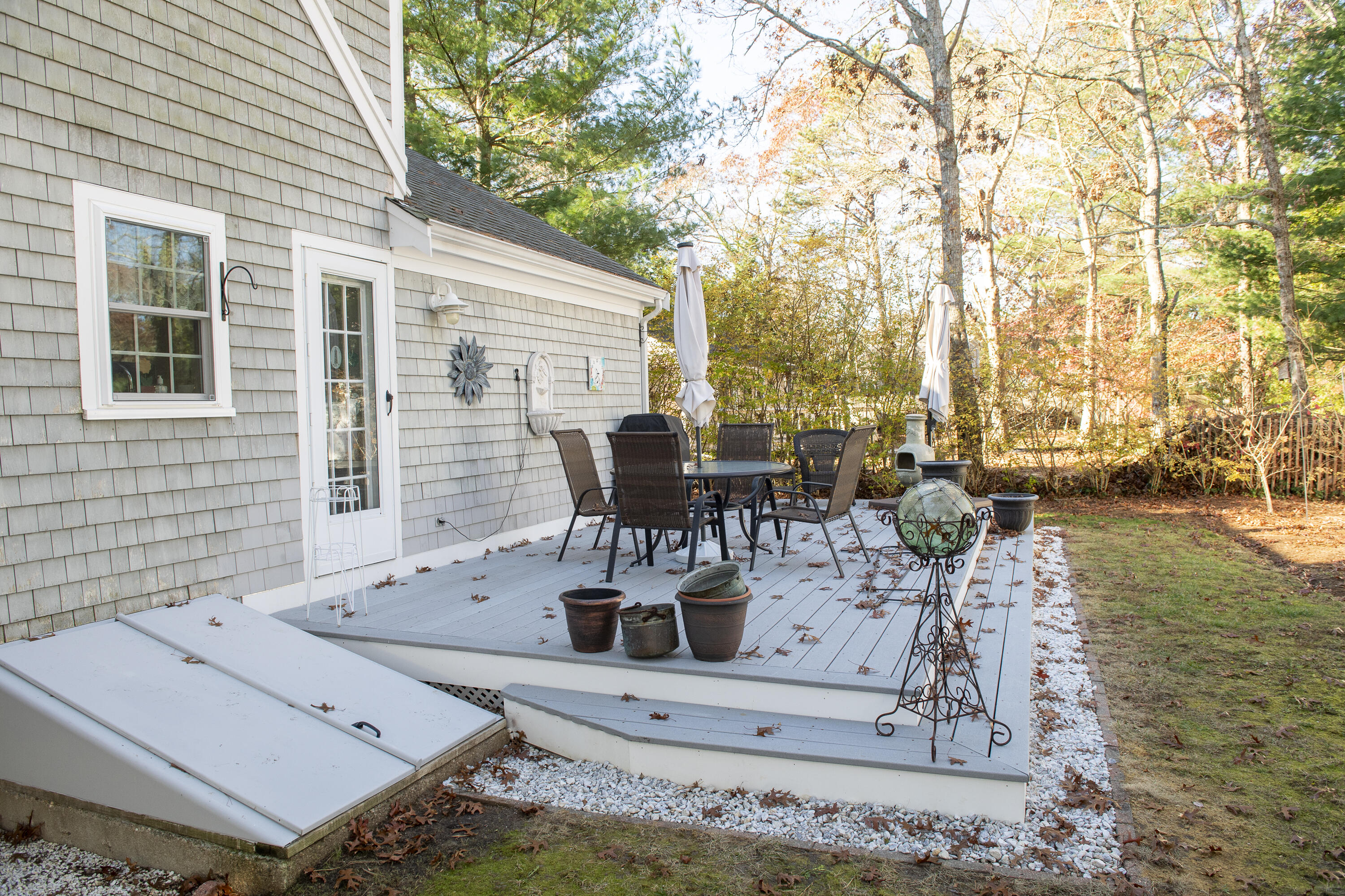 31 Mashpee Neck Road Mashpee, MA 02649 - Photo 49 of 65 a view of a patio with table and chairs and potted plants