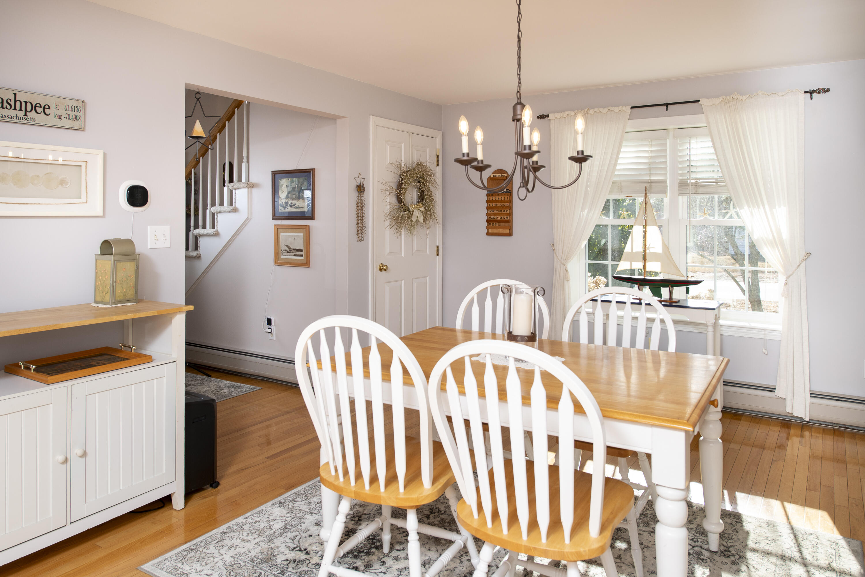 31 Mashpee Neck Road Mashpee, MA 02649 - Photo 5 of 65 a view of a dining room with furniture and wooden floor