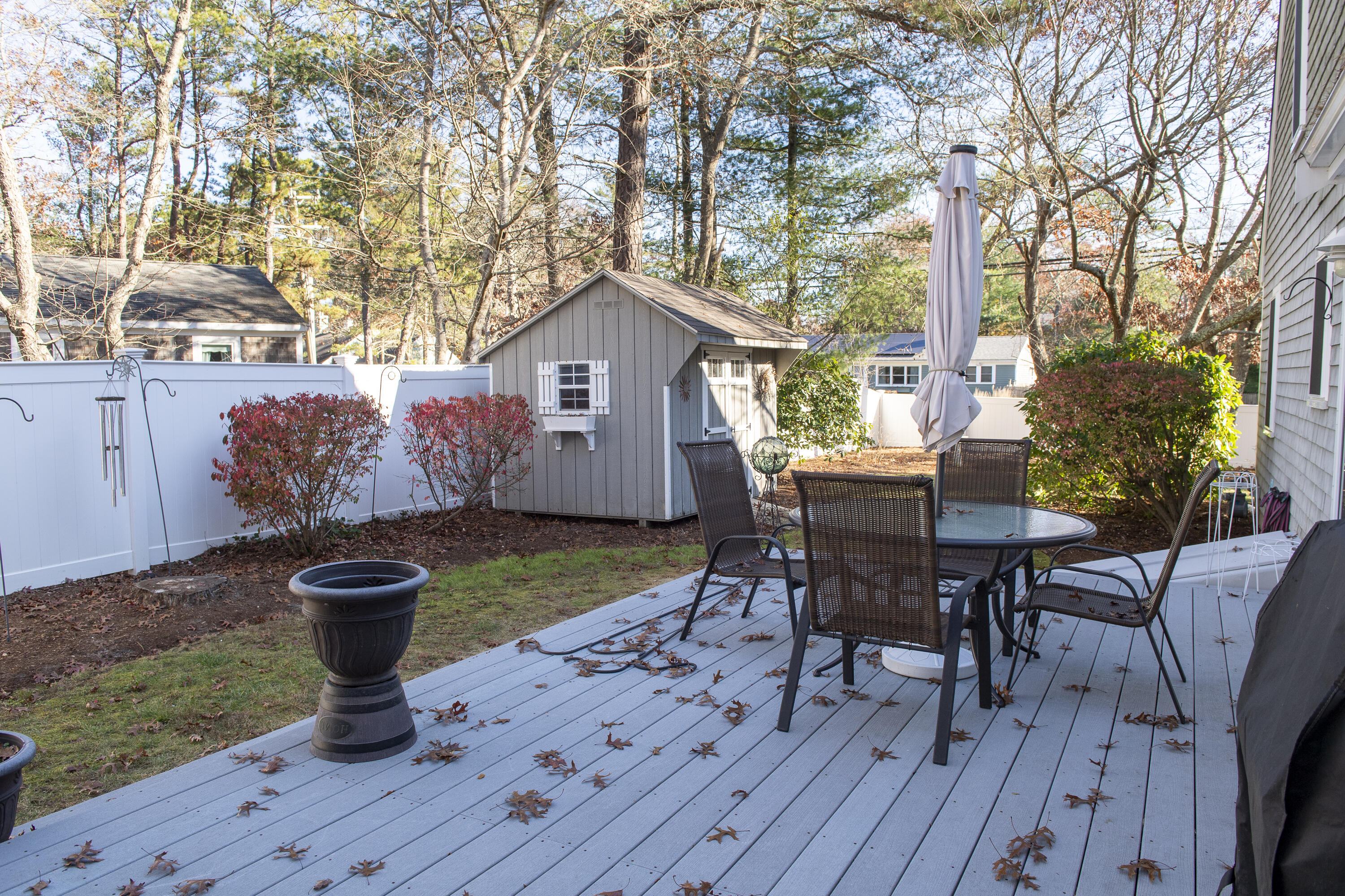 31 Mashpee Neck Road Mashpee, MA 02649 - Photo 52 of 65 a view of a chairs and table on the wooden deck