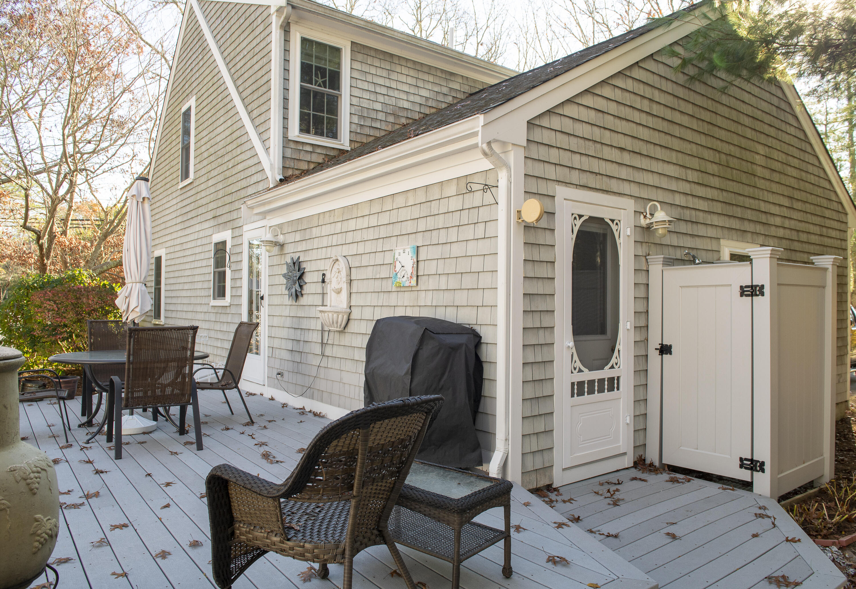 31 Mashpee Neck Road Mashpee, MA 02649 - Photo 56 of 65 a view of a patio with table and chairs and wooden floor