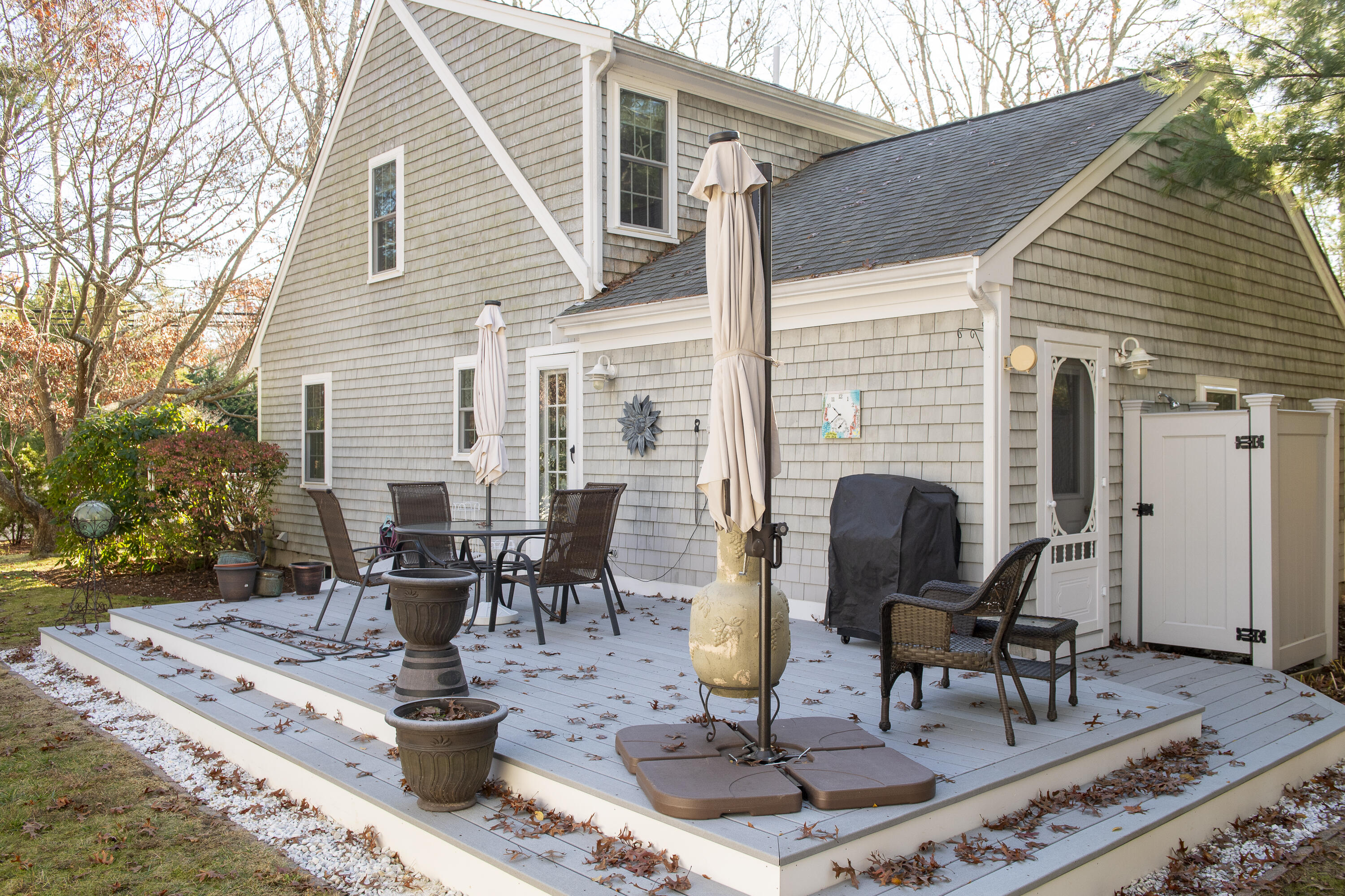 31 Mashpee Neck Road Mashpee, MA 02649 - Photo 57 of 65 a view of a patio with table and chairs and potted plants
