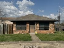 2811 Sprucewood Street, Unit A Bryan, TX 77801 - Photo 1 of 1 a front view of a house with garage