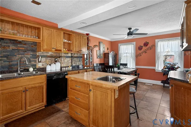 a kitchen with a stove sink and cabinets