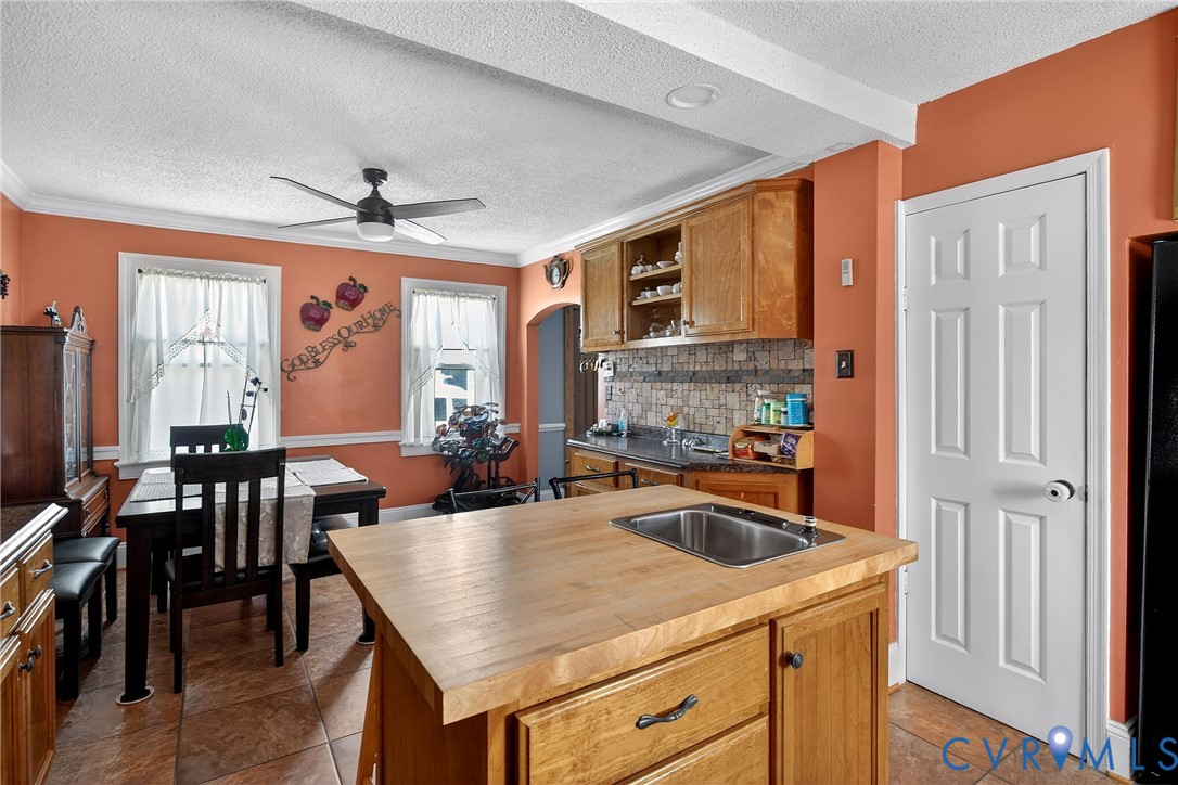919 Colonial Avenue Colonial Heights, VA 23834 - Photo 12 of 31 a kitchen with a stove a refrigerator a dining table and chairs