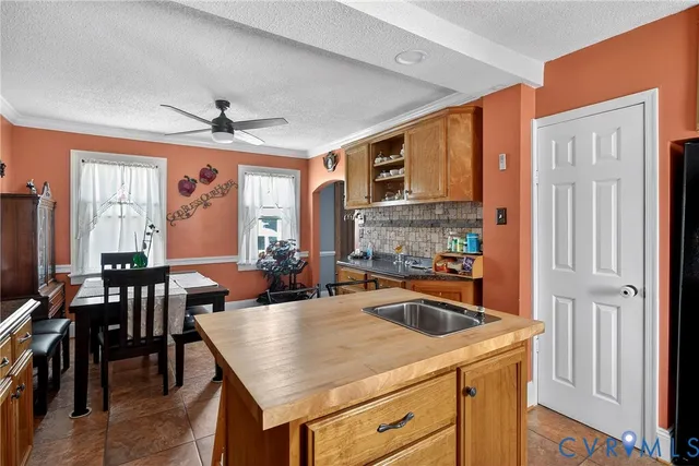 a kitchen with a stove a refrigerator a dining table and chairs