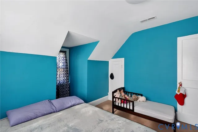 a bedroom with a bed and a couch